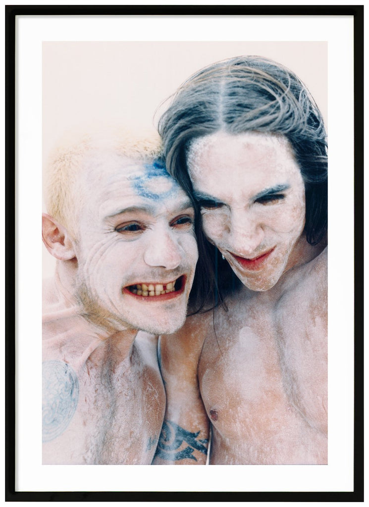 Poster av porträtt av två män med vit färg i ansiktet och på överkroppen. Svart ram.