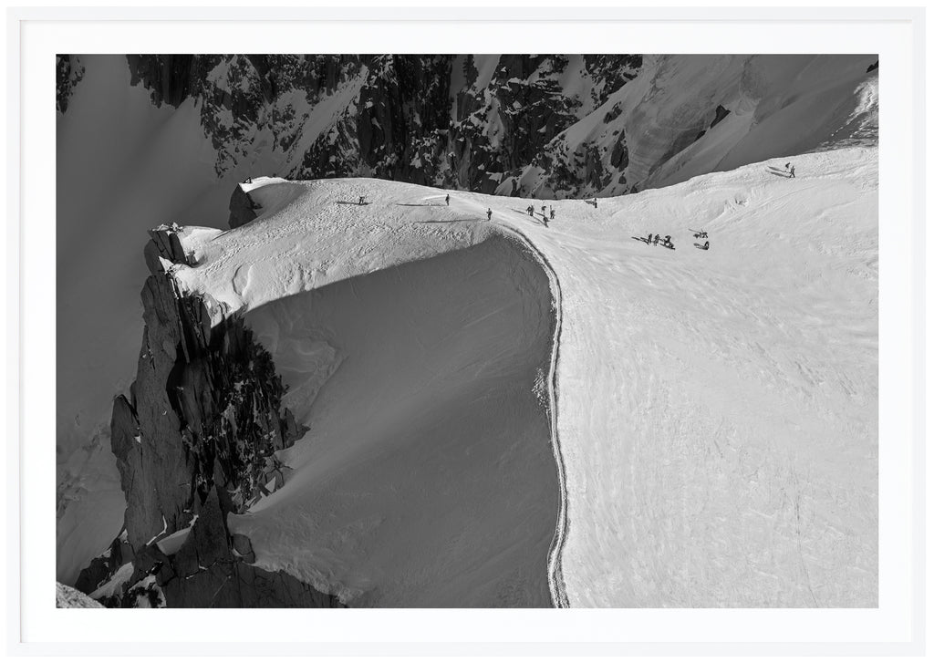 Svart-vit poster ur fågelperspektiv av den snötäckta kammen vid Aiguille. Vit ram